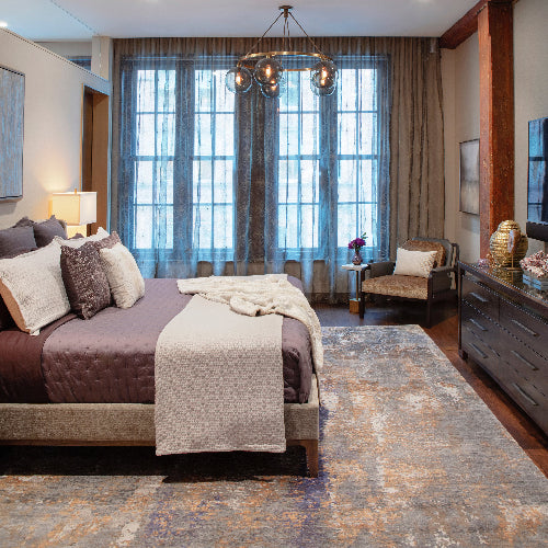 A bedroom with a Tufenkian carpet.