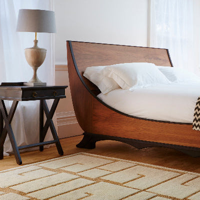 A bedroom with a Tufenkian carpet.