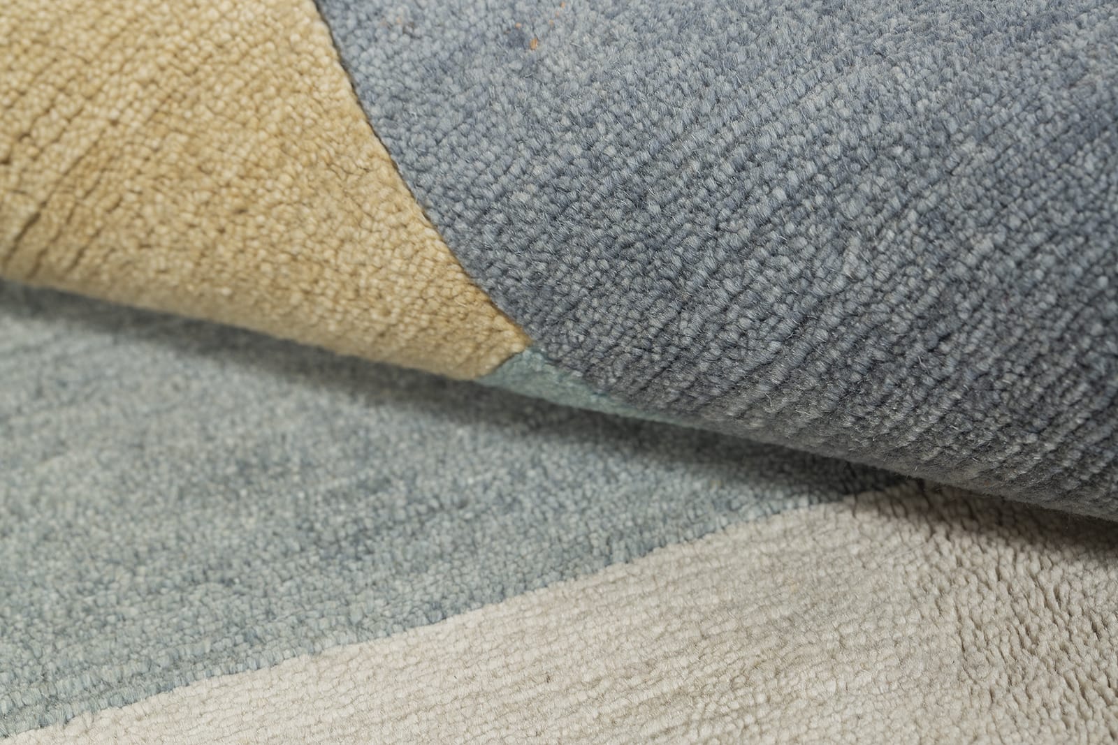 detail image of Monolith Light Blue hand knotted area rug design by Tufenkian