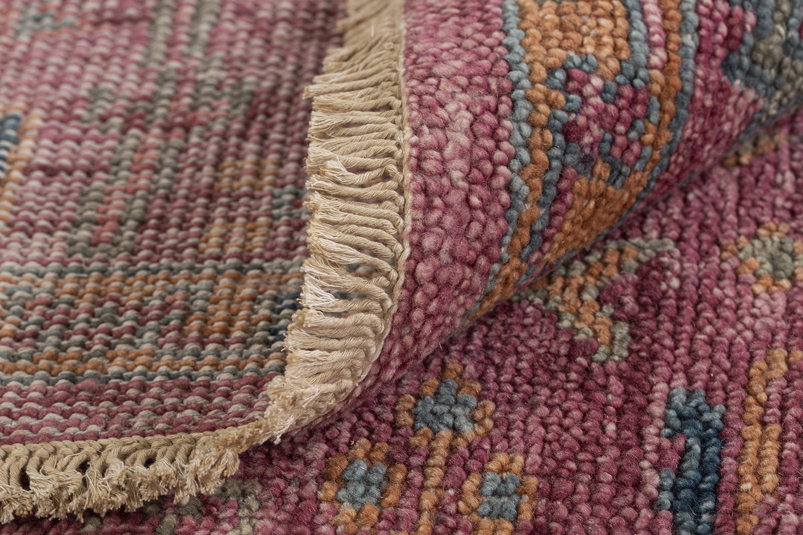 detail image of Tigranakert Rouge hand knotted area rug design by Tufenkian